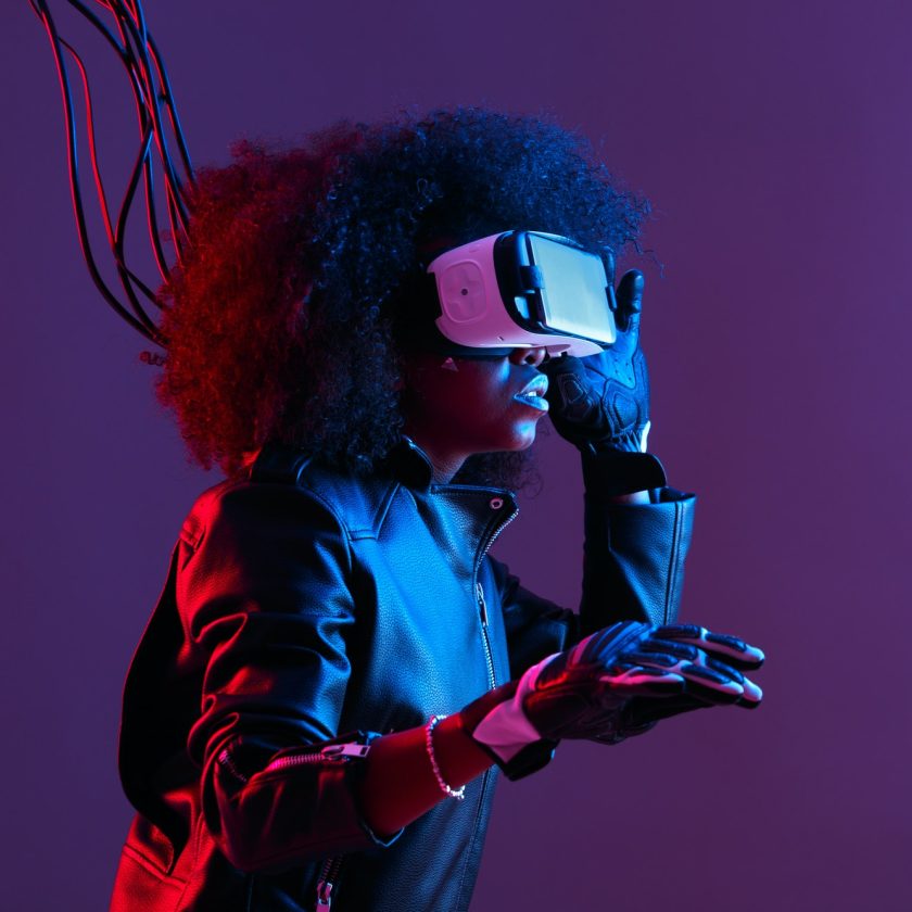 mod-curly-dark-haired-girl-dressed-in-black-leather-jacket-and-gloves-uses-the-virtual-reality.jpg
